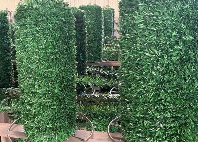Artificial conifer fencing for green outdoor spaces