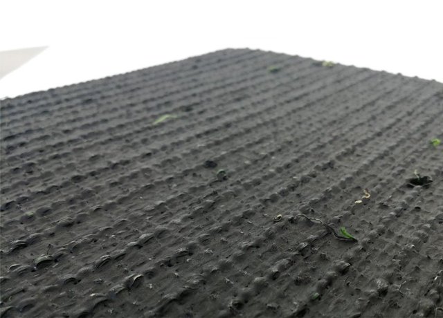 Pet friendly synthetic grass with permeable backing for easy-drain pet areas