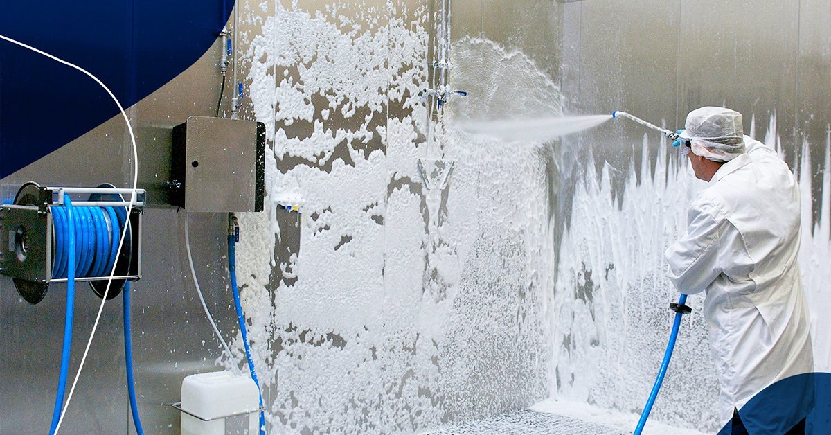 Technician performing monthly descaling procedure on central foam cleaning station valve body